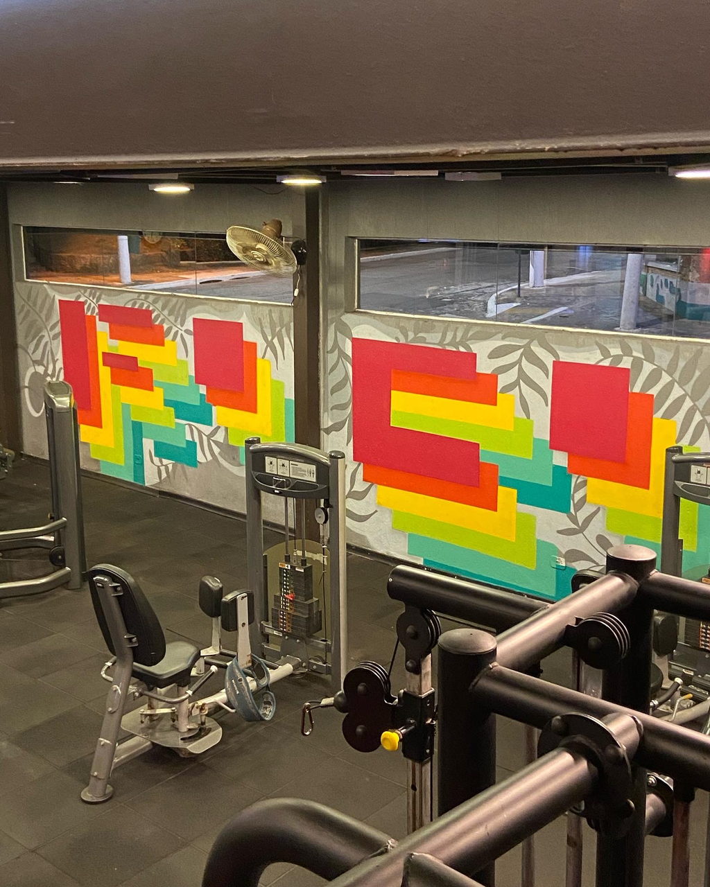 Gym mural with stepped lettering in red and green