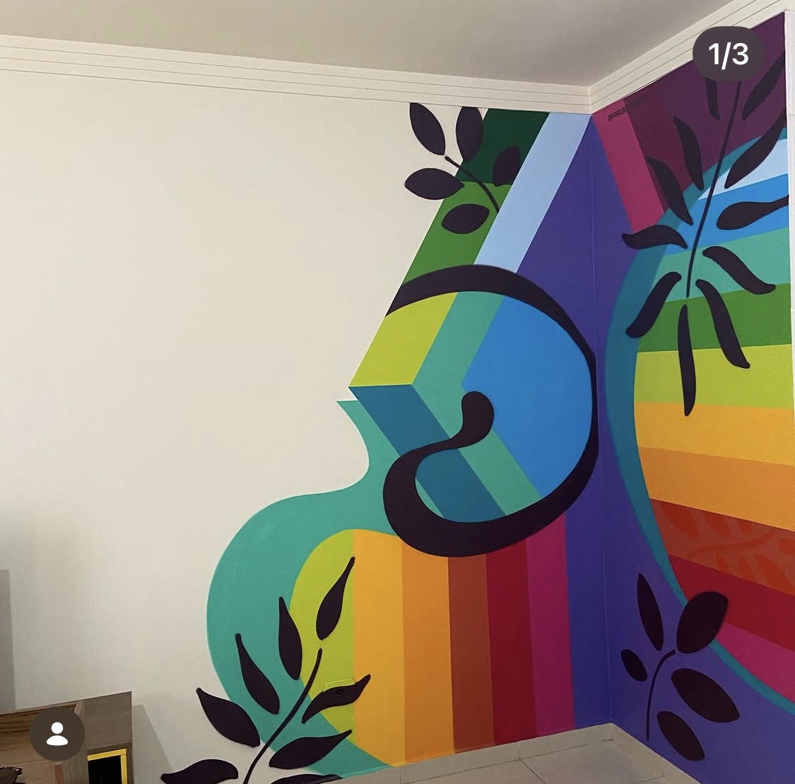 Interior mural in rainbow bands with black foliage